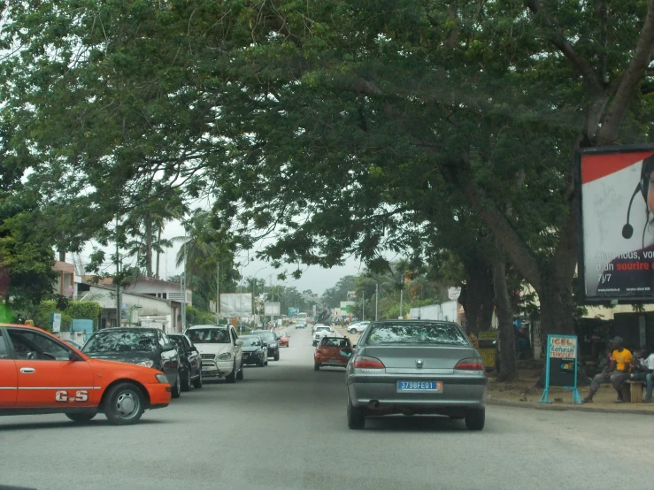 cars parked on the street next to trees