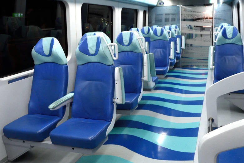 the train's blue seats are empty and are painted blue