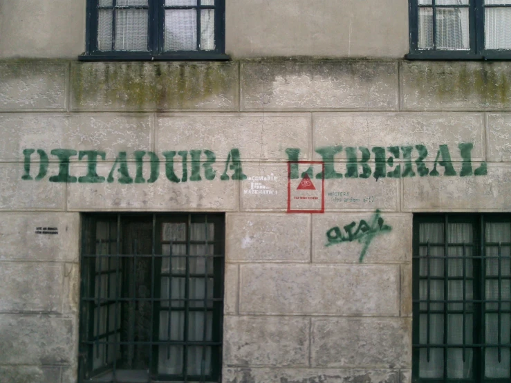 a large building with windows and graffiti on it