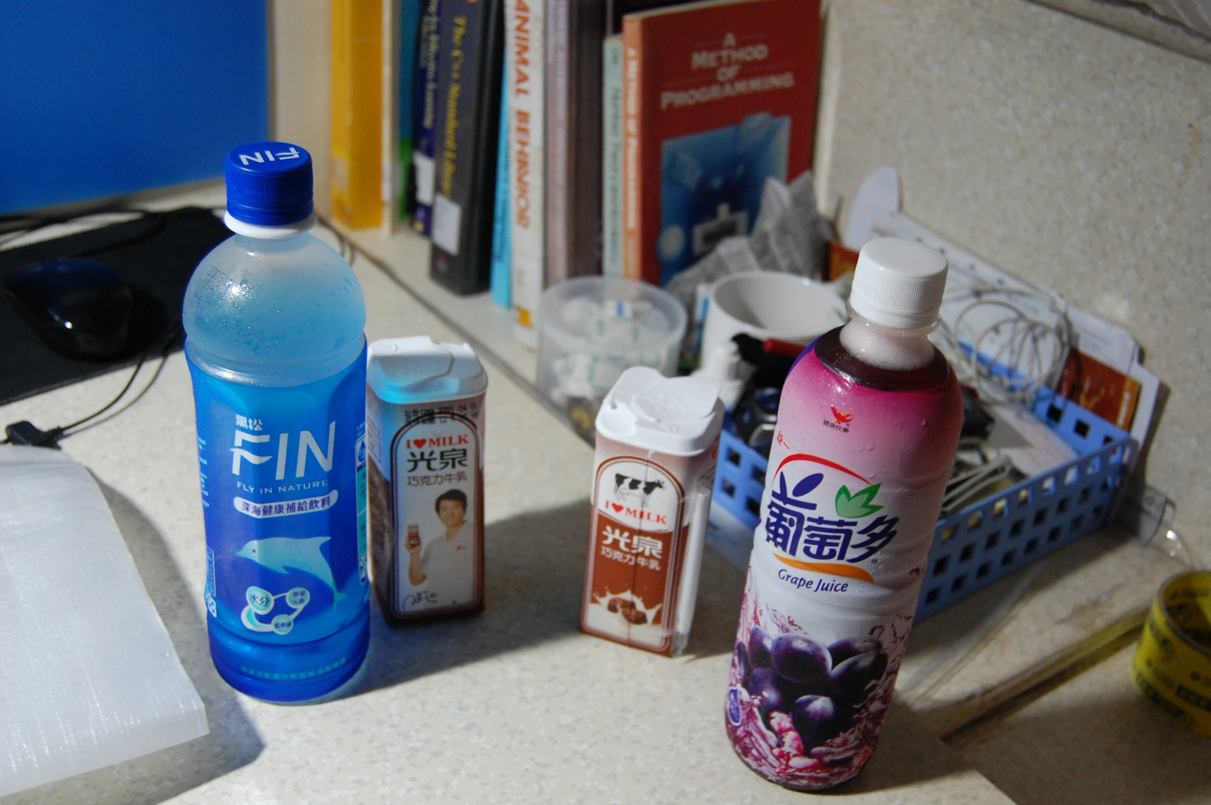 a couple bottles of water sitting on top of a desk