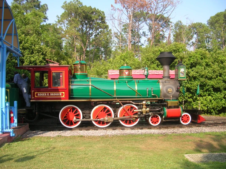 there is an antique train displayed in a park