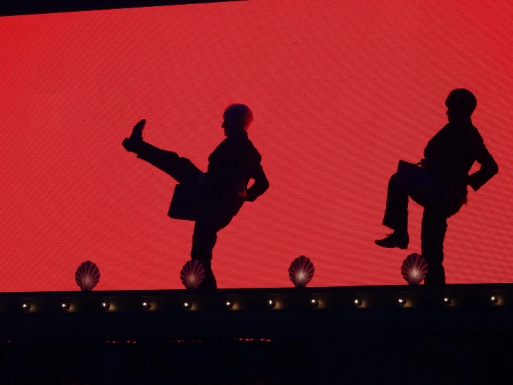 silhouettes are on a lighted screen on the floor
