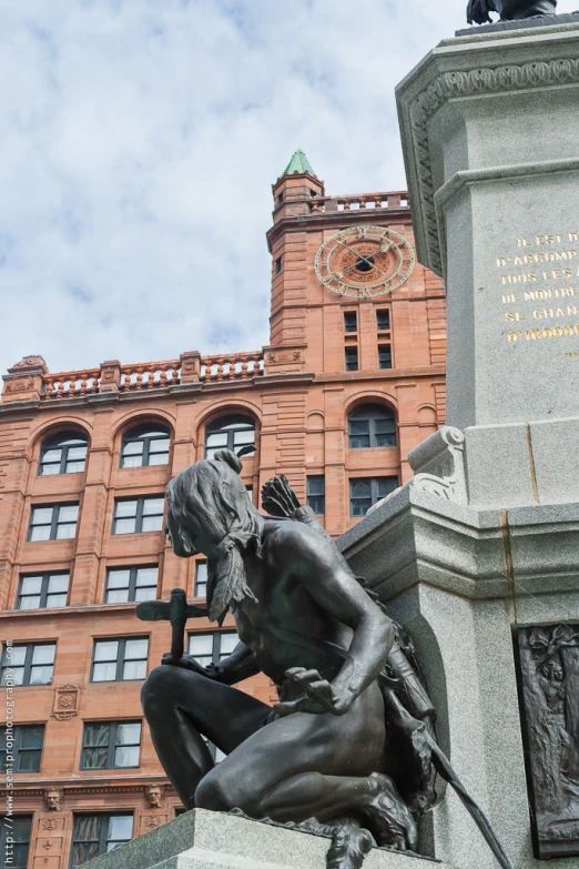 a statue on a pedestal in front of a building