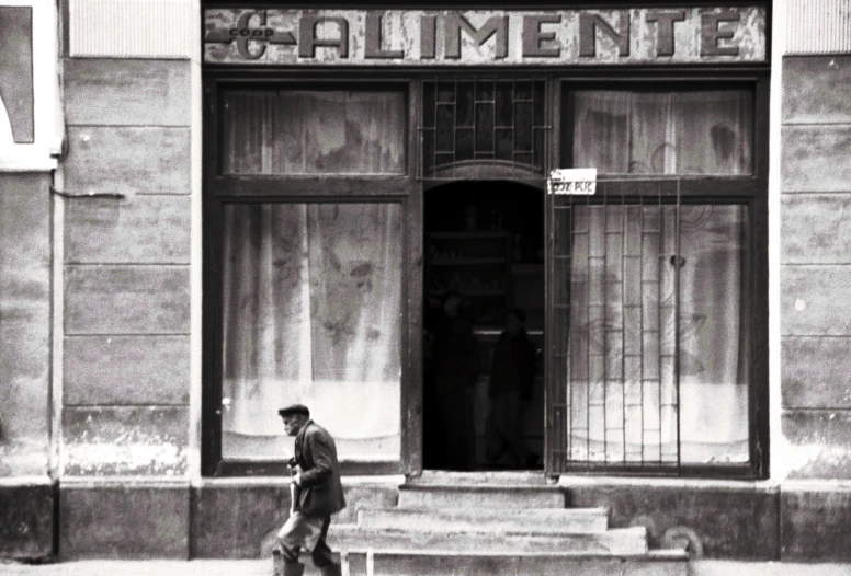 the man is walking past a department store