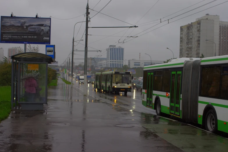 a group of busses are parked on the side of a street