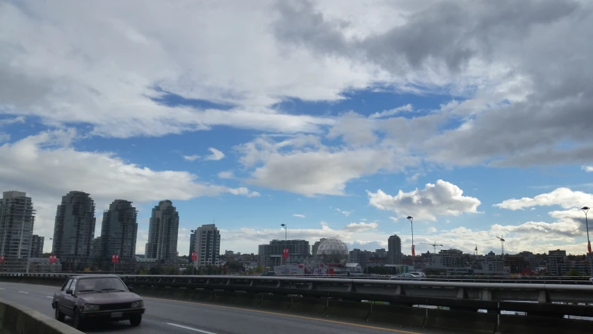 a car driving on a highway in front of an overpass