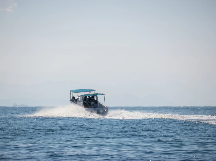 a boat rides across the blue waters near shore