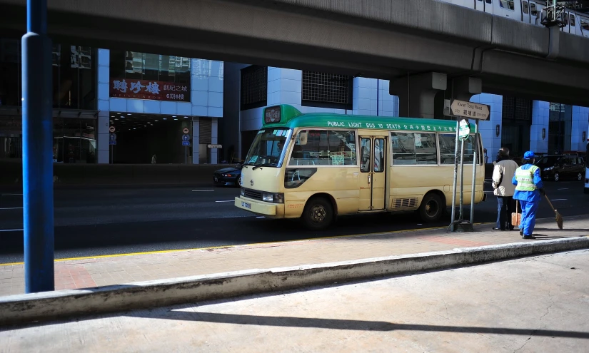 an image of a city bus stopping at the curb