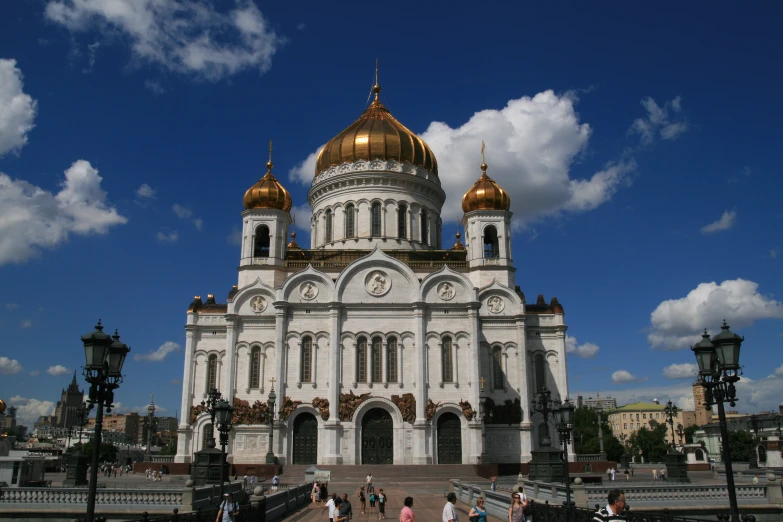 an image of a large church building that has golden domes