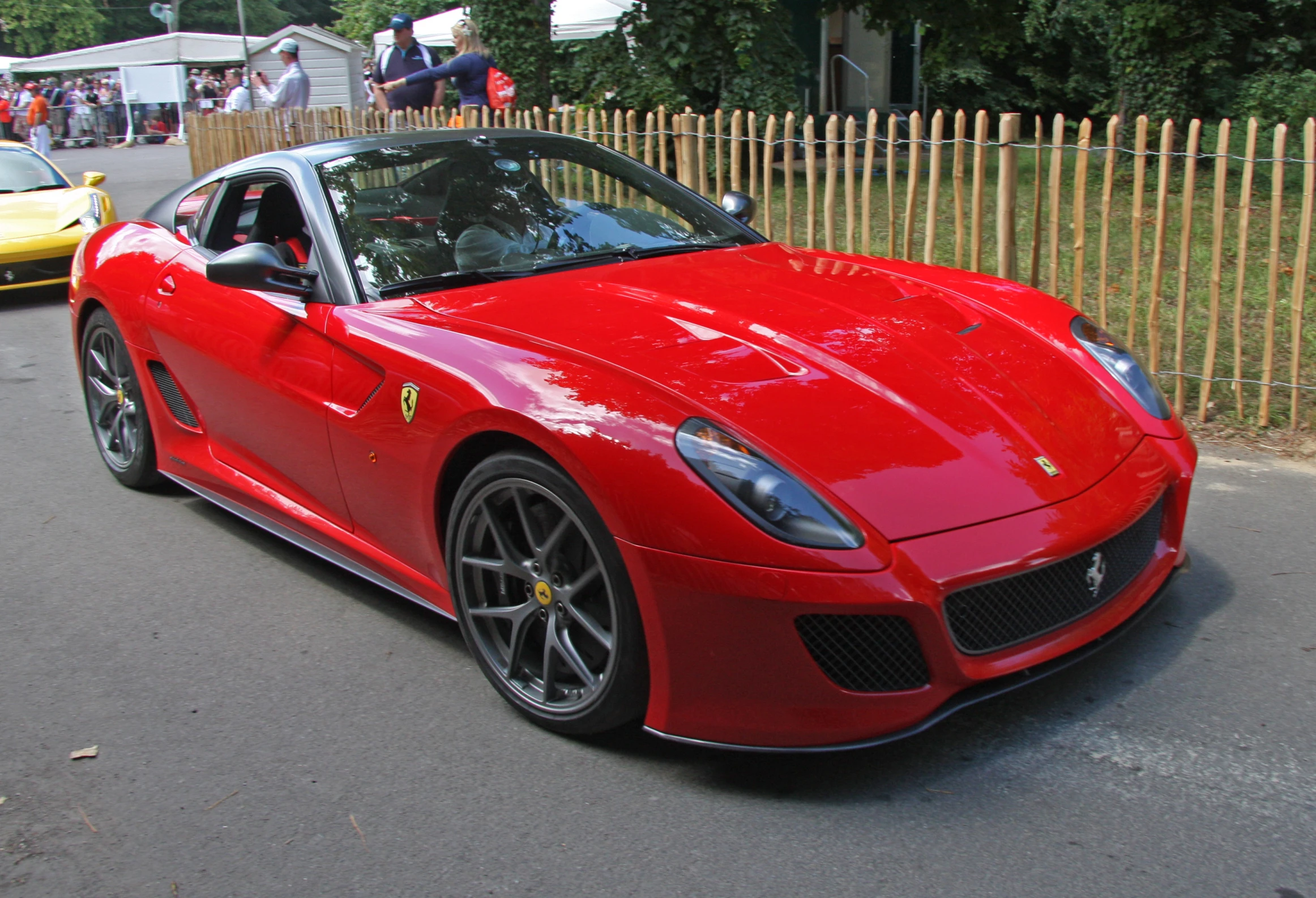 there is a red ferrari that is parked on the street