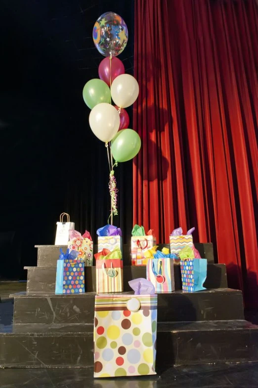 balloon, present boxes and other gifts on stage