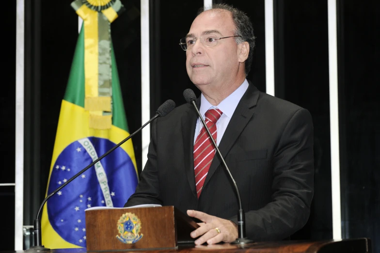 a man standing at a podium with an empty microphone