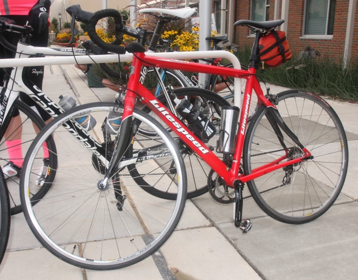 a red bicycle is parked at a station