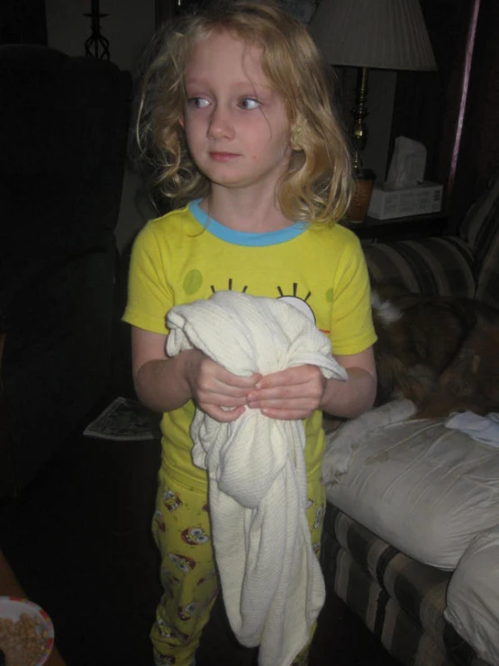 a  in pajamas holding a white blanket