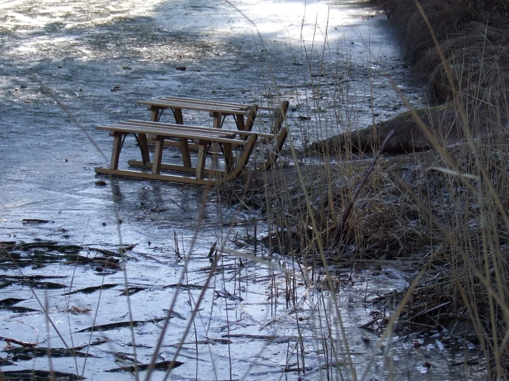 a bench is sitting in the middle of a stream