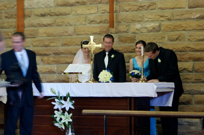 some people standing at the alter of a church