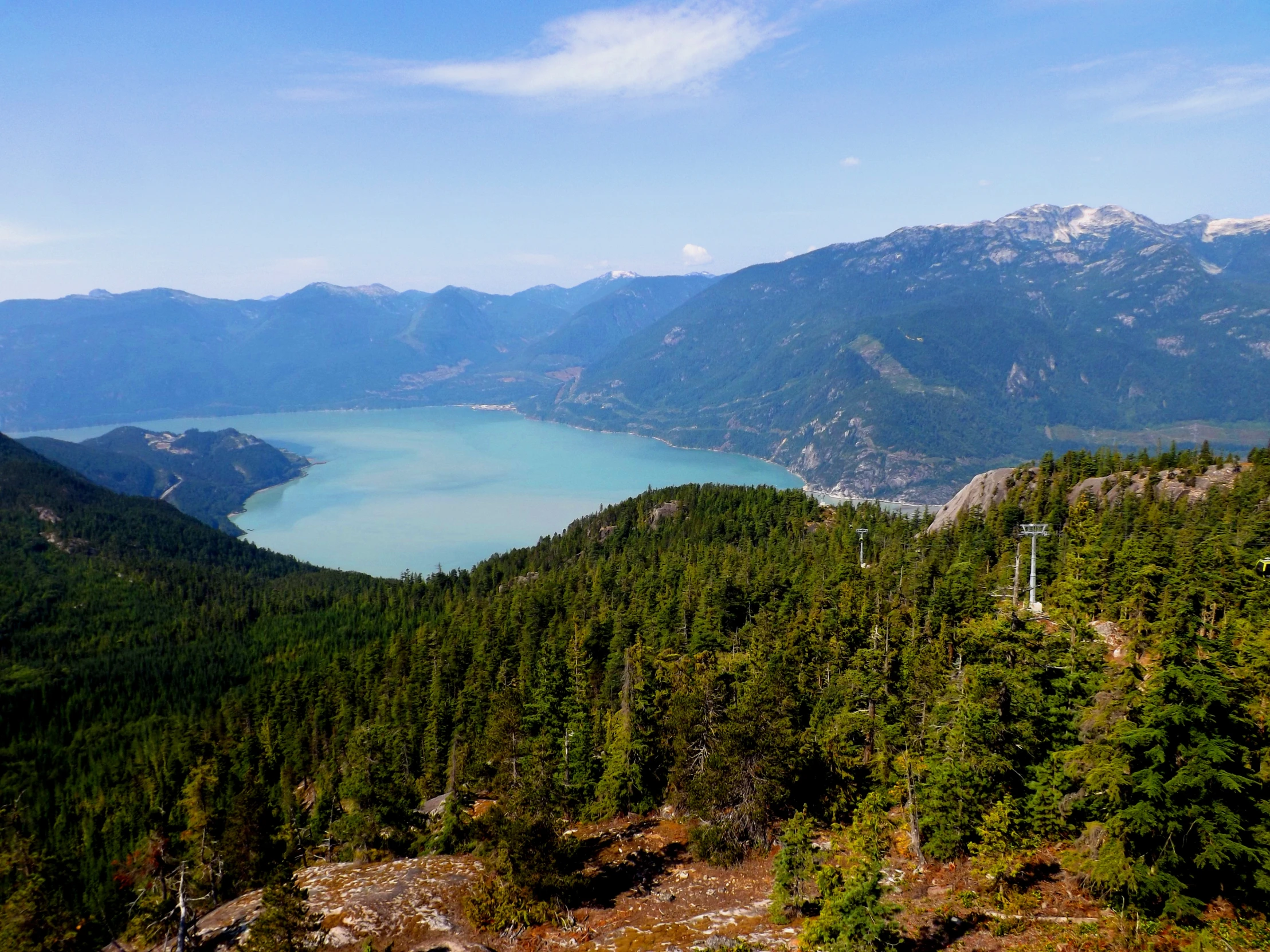 the mountain top overlooking a lake is very pretty