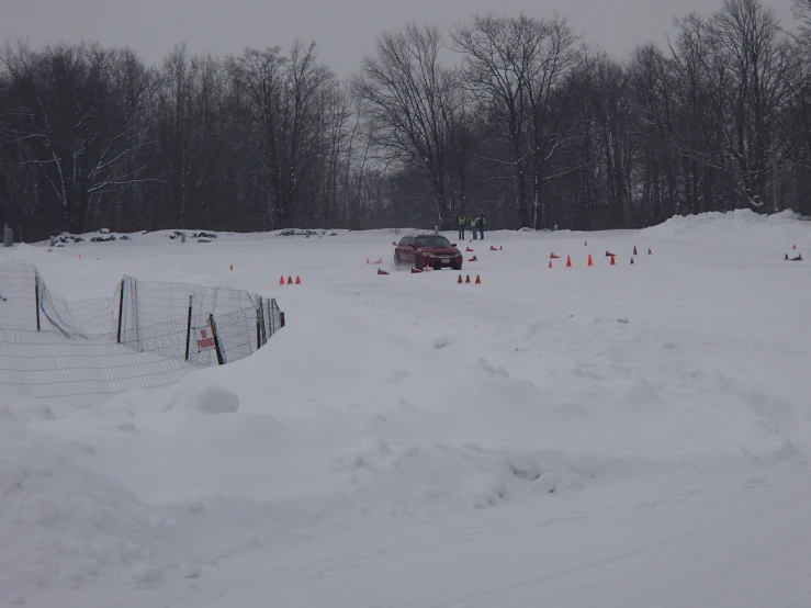 a car driving on a road with snow on it