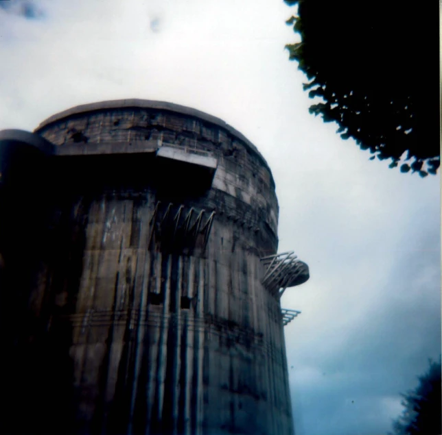 view of the side of an old tower with a clock on it