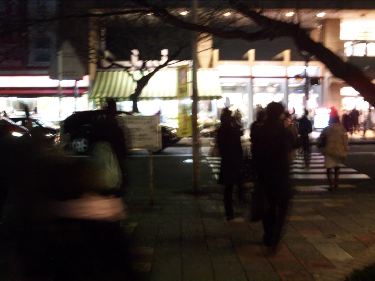 a night scene of a city street and stores on it