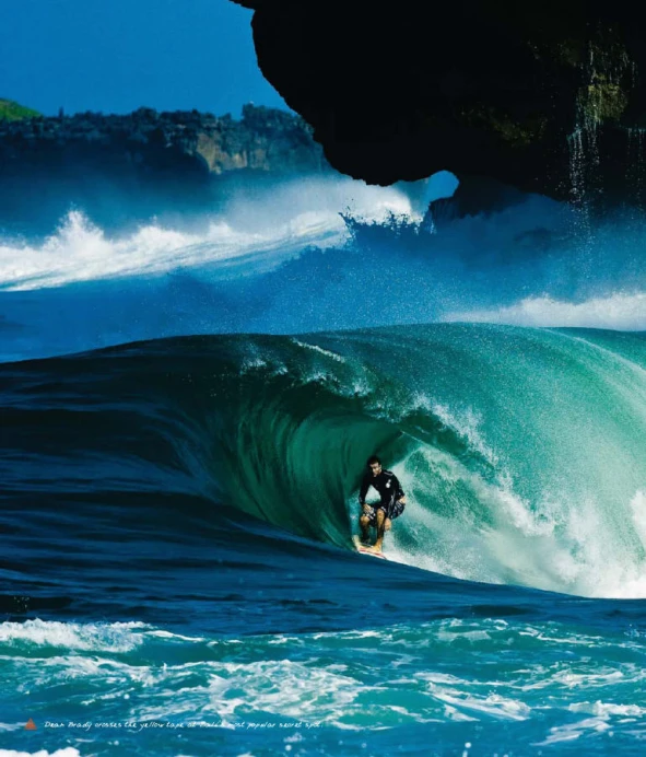 a surfer rides an impressive wave in the ocean