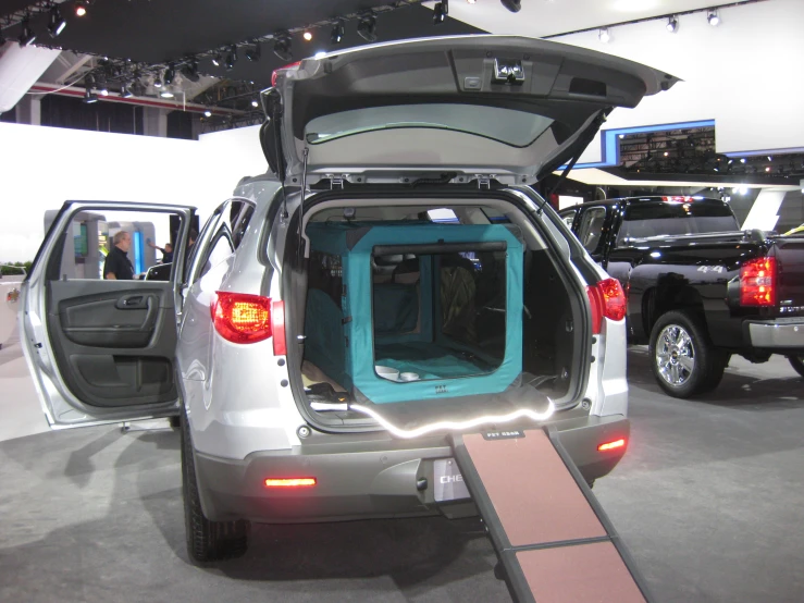 the back end of a silver truck with doors open