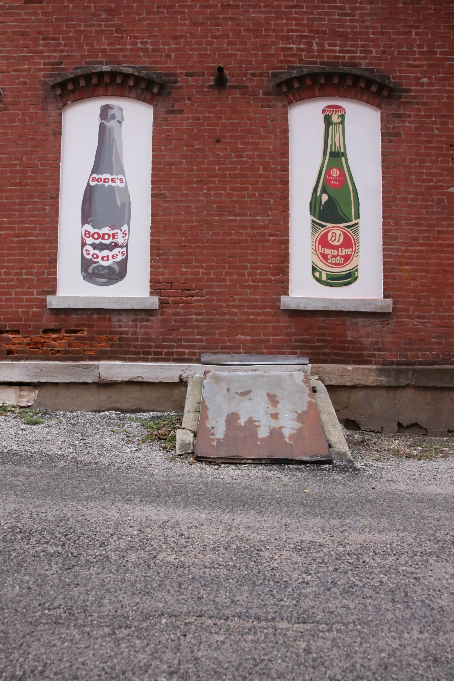 two bottles of beer are on the side of the building