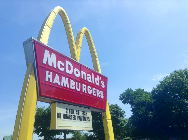 a mcdonald's hamburger restaurant sign with a large yellow arch