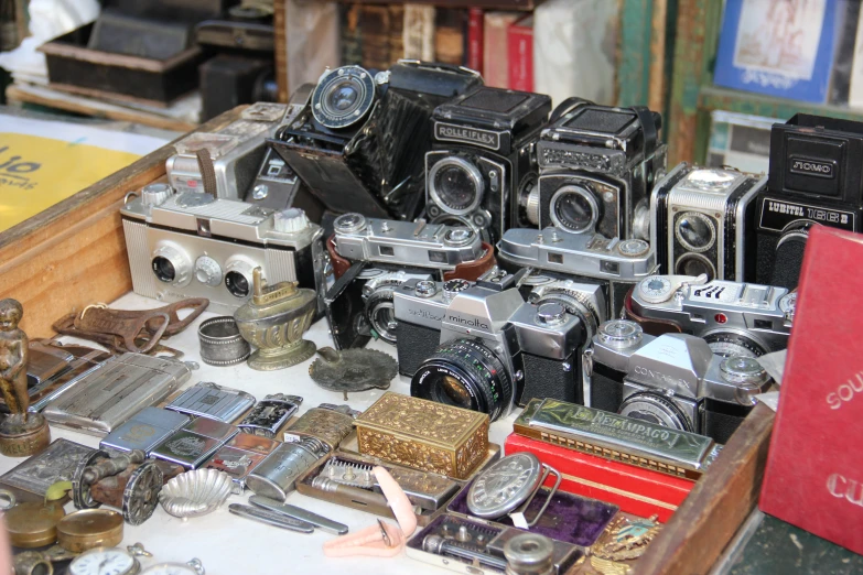 old and used cameras displayed on display in antique shop