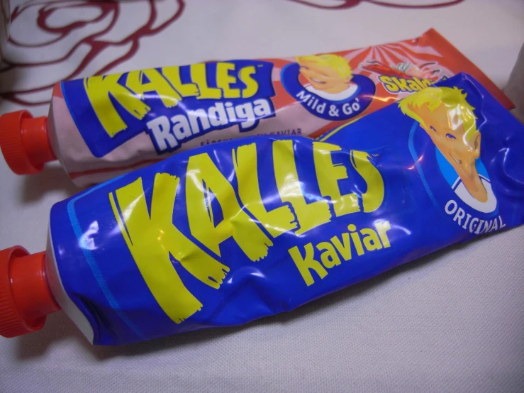 two packs of kayles kaval sitting on a bed