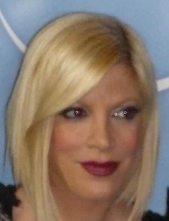 a blonde woman with dark lipstick on the face