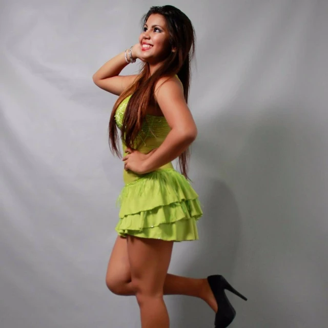 a woman in a short lime green dress poses for a po