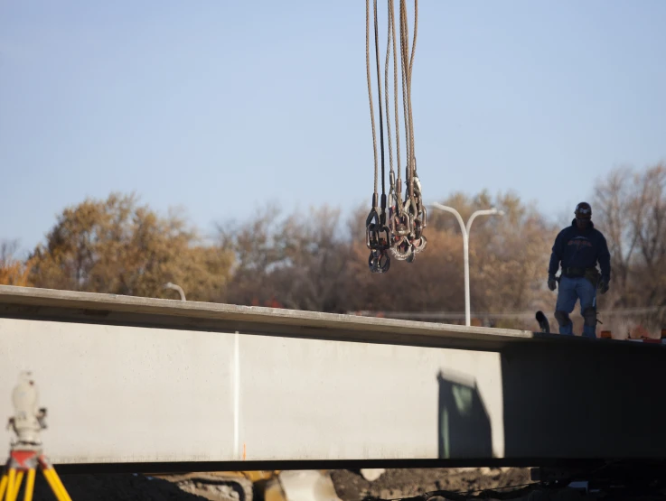 a man is standing on top of a concrete bridge