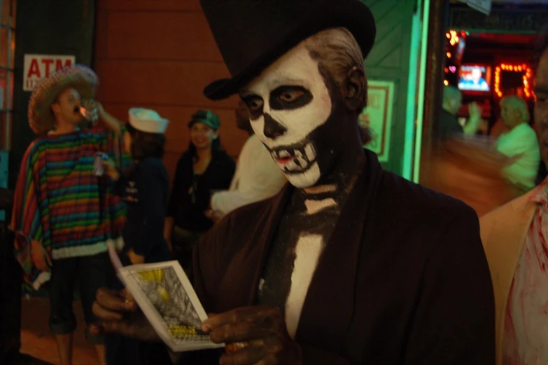 two men dressed in scary costumes are reading a magazine