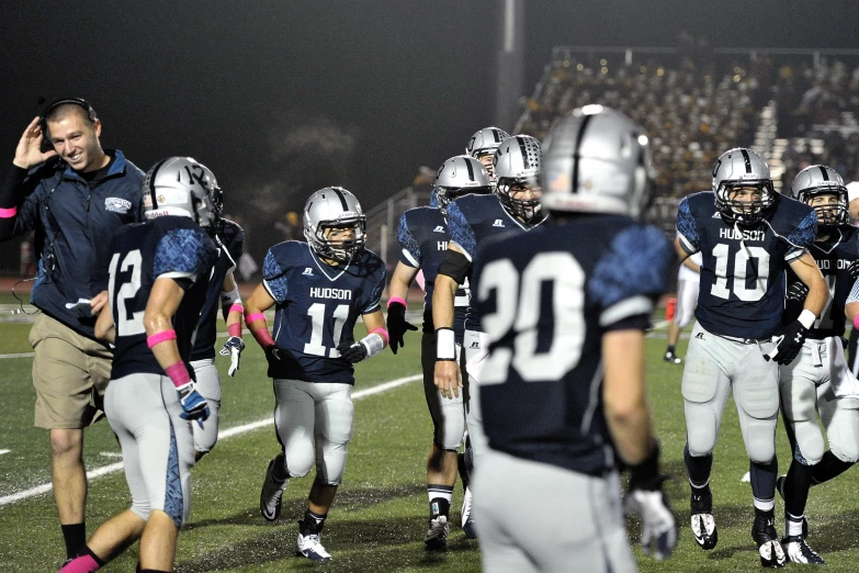 the football team is running on the field