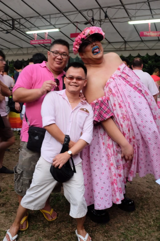 three people posing for the camera while wearing pink and white outfits