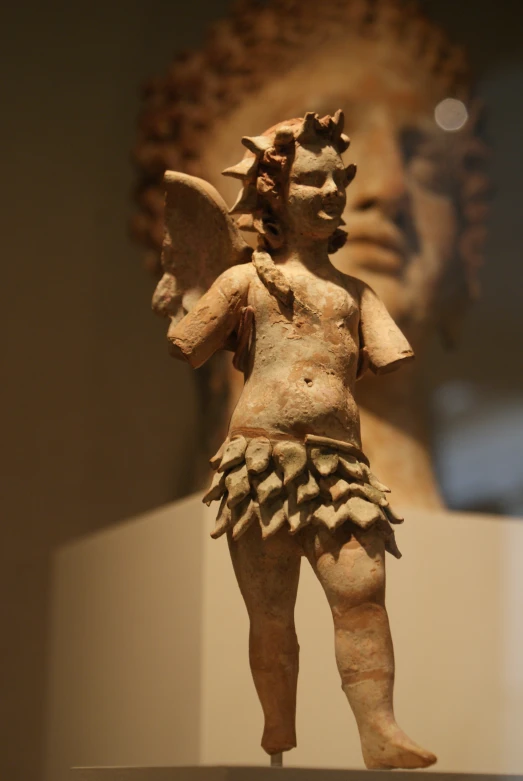 a statue of an asian male with wings and armor