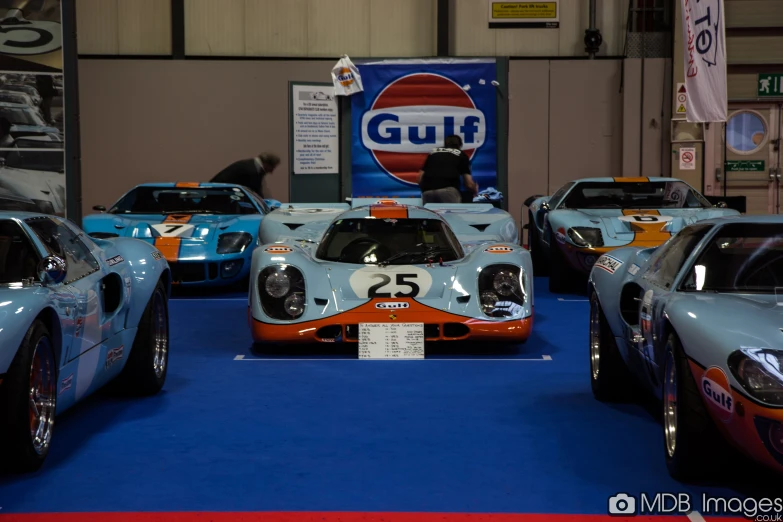 a display of vintage race cars in a car showroom