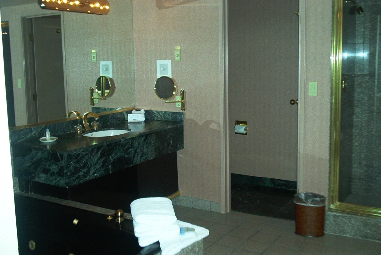 there is a bathroom that has marble counters and a big vanity