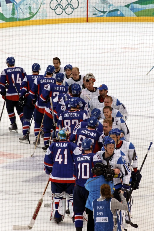 a group of men on a hockey court playing hockey