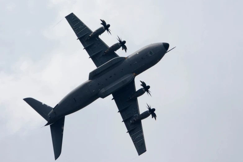 a large military airplane flying thru the sky