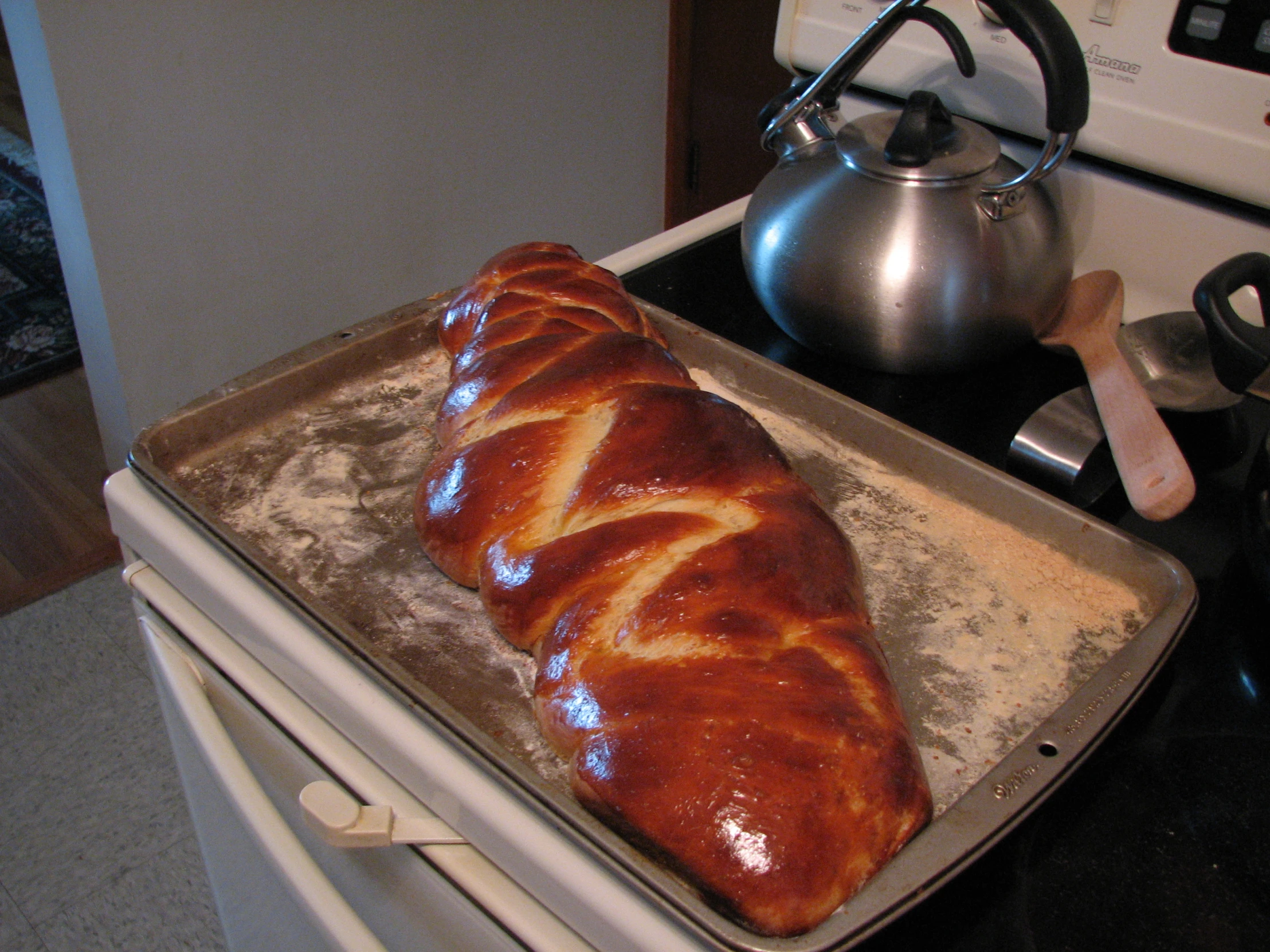 an uncooked loaf of baked bread sitting on top of an oven