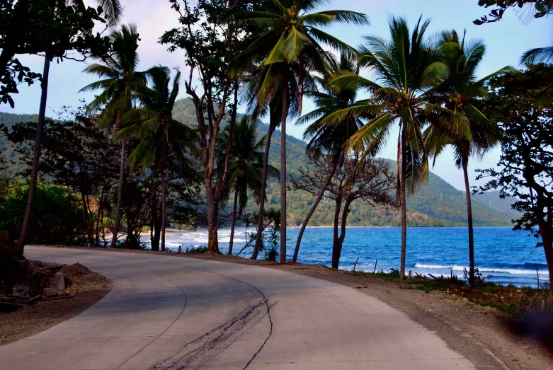 a view of a road running next to the ocean