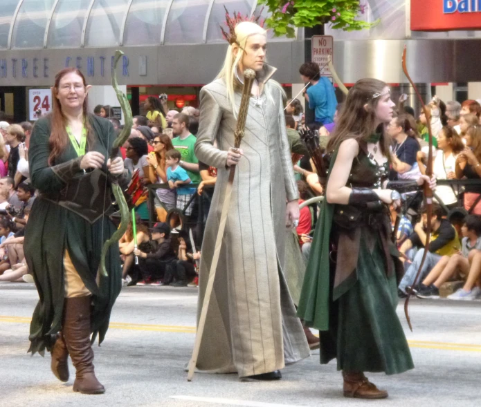 a group of people walking down a road in a parade