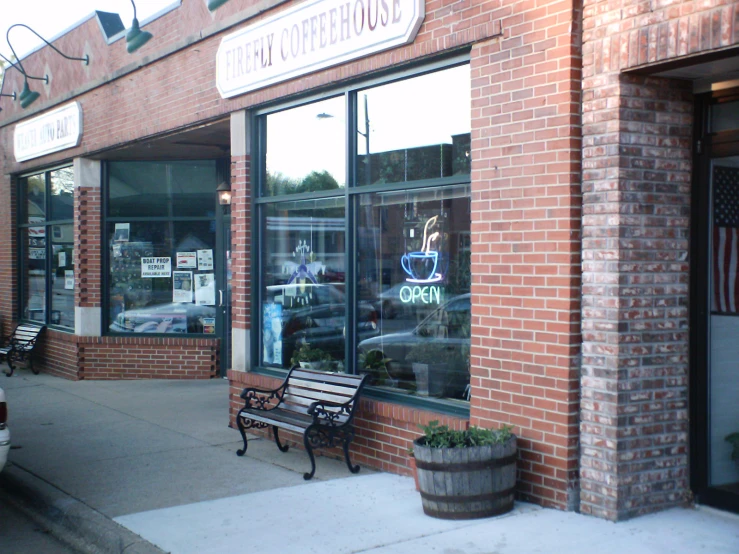 a storefront with a wooden bench outside it