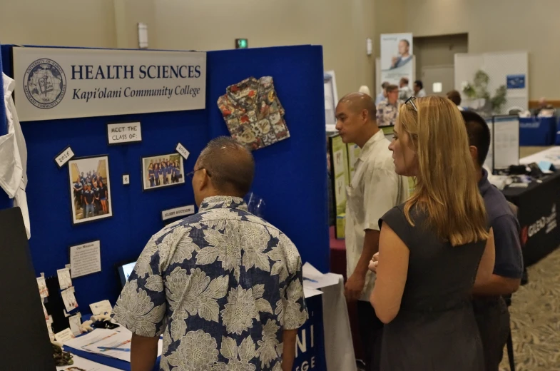 a man looking at information displayed at an event