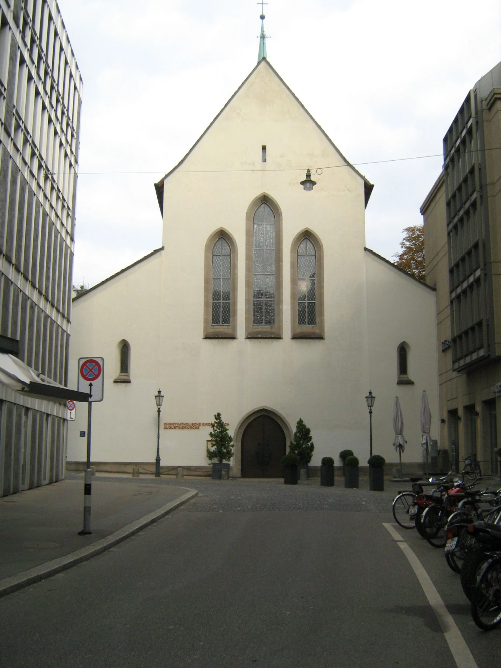 an old church is decorated with windows and has motorcycles parked in the front