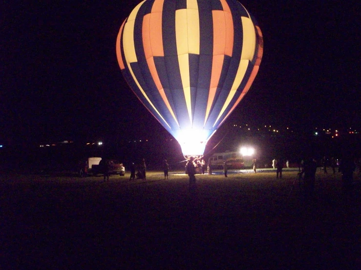 a multi colored  air balloon lit up at night