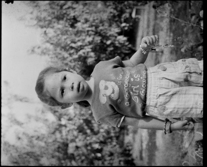 a young child holding a toothbrush up to his teeth