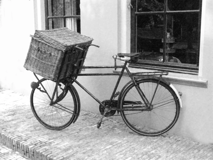 black and white image of bike with basket attached